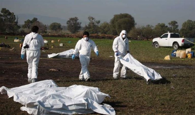 Victims' remains are removed from the scene of the Hidalgo explosion and fire.