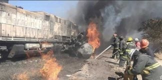 Firefighters at the scene of the tanker truck-train crash.