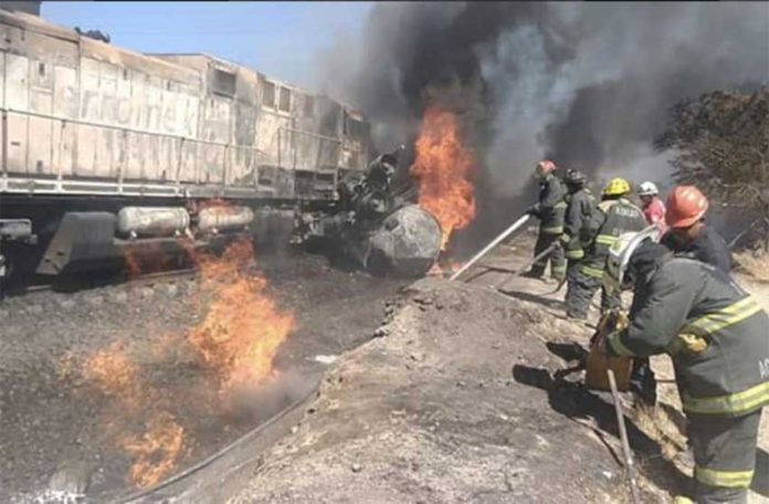 Firefighters at the scene of the tanker truck-train crash.