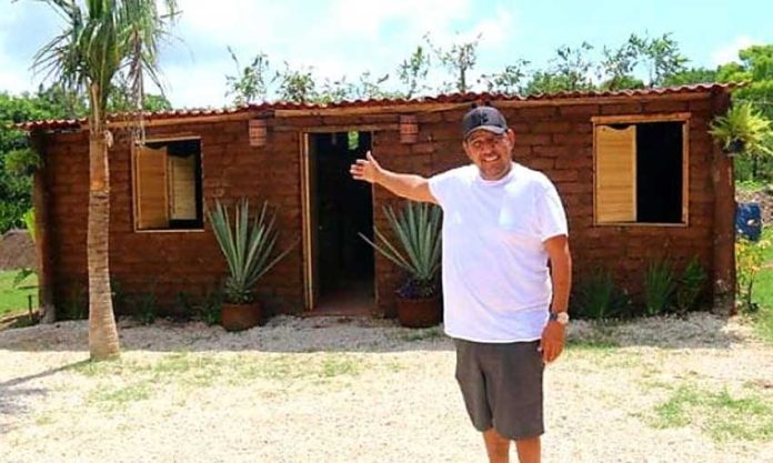 Vázquez and his sargassum house in Quintana Roo.