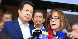 Delgado and Polevnsky speak with reporters yesterday.