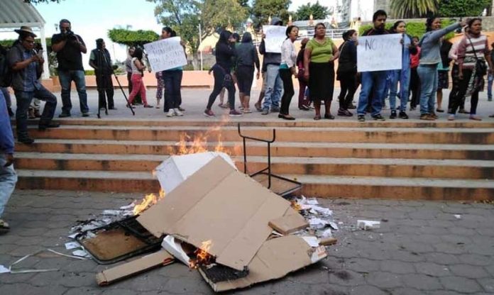Ballots and documents burn at a polling station in Morelos.