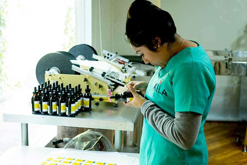 Production chief Wendy Rodríguez prepares labels for the company's selection of cocktail bitters. 