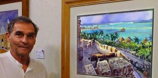 Jorge Monroy with his watercolor, The Lake of Seven Colors at Bacalar.