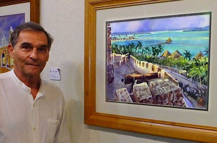 Jorge Monroy with his watercolor, The Lake of Seven Colors at Bacalar.