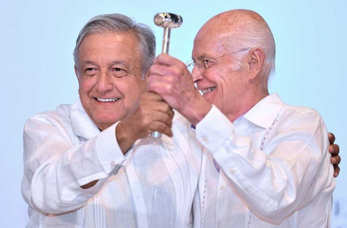 López Obrador, left, presents the official gavel of office to new bankers' association president Niño de la Rivera.
