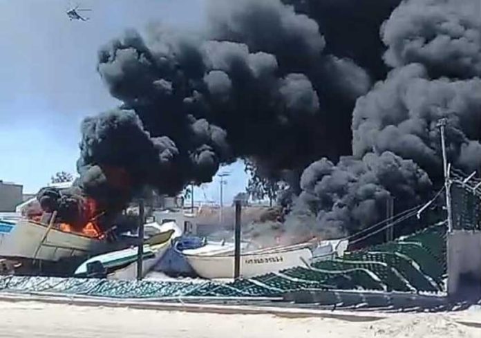 Burning boats in Thursday's clash in San Felipe.
