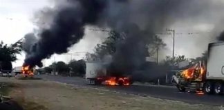 Trucks burn on a Veracruz highway.