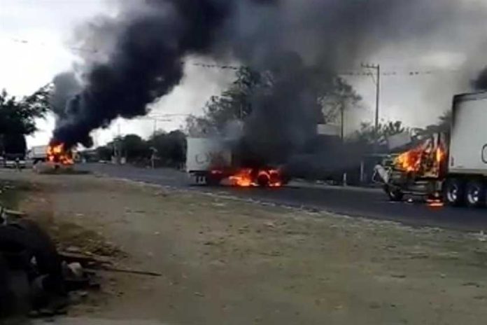 Trucks burn on a Veracruz highway.