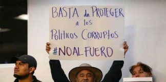 'No more protection for corrupt politicians,' reads the sign of a supporter of eliminating the fuero.