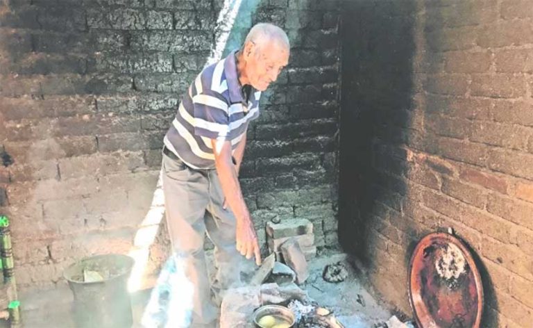 Medina cooks potatoes at his home in Michoacán.