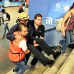 Metro staff carry a subway user up the stairs in Mexico City.