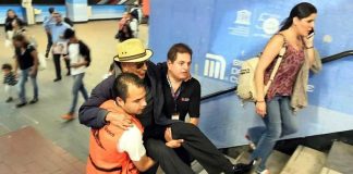 Metro staff carry a subway user up the stairs in Mexico City.