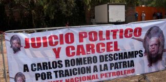 The Pemex union leader was absent from the party but signs demanding he be jailed were not.