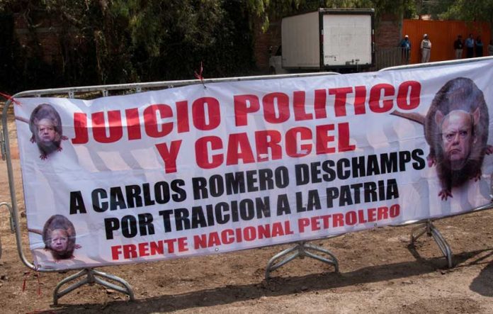 The Pemex union leader was absent from the party but signs demanding he be jailed were not.