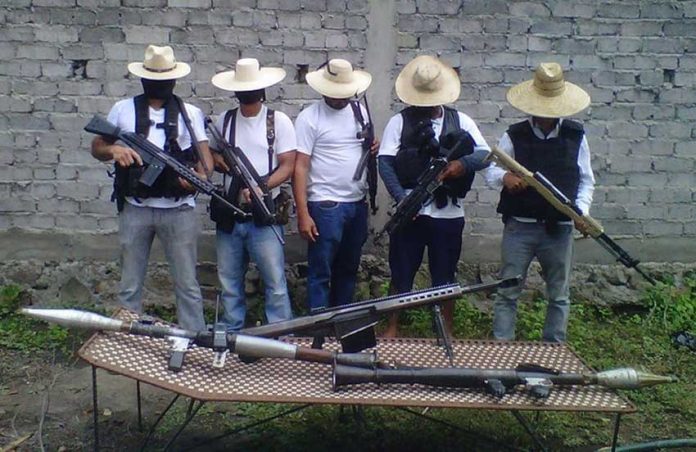 Los Blancos de Troya, suspected of stirring things up in Michoacán, display some firepower in a 2015 photo.