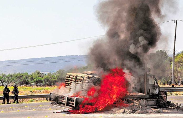A vehicle burns at a Guanajuato highway blockade yesterday.
