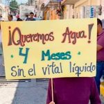'We want water,' reads the sign of a protester who has not had any for four months.