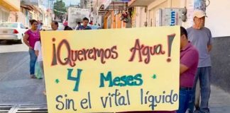 'We want water,' reads the sign of a protester who has not had any for four months.