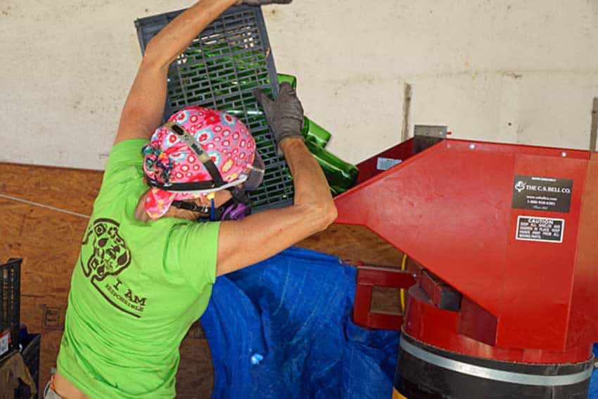 glass crusher quickly reduces a weekly bottle collection to crushed glass.