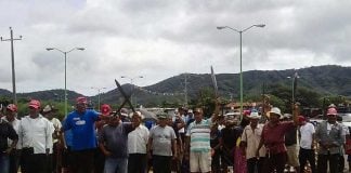 San Dionisio residents raise machetes in protest in 2014.