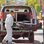 Forensic personnel retrieve bodies in Zapopan.