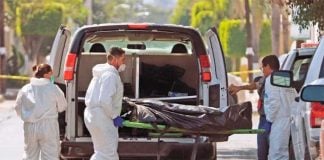 Forensic personnel retrieve bodies in Zapopan.