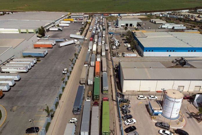Trucks line up to cross the border at Otay Mesa in Tijuana.