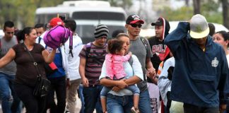 Migrants leave San Pedro Sula last night.