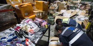Customs agents inspect goods seized at Mexico City airport.