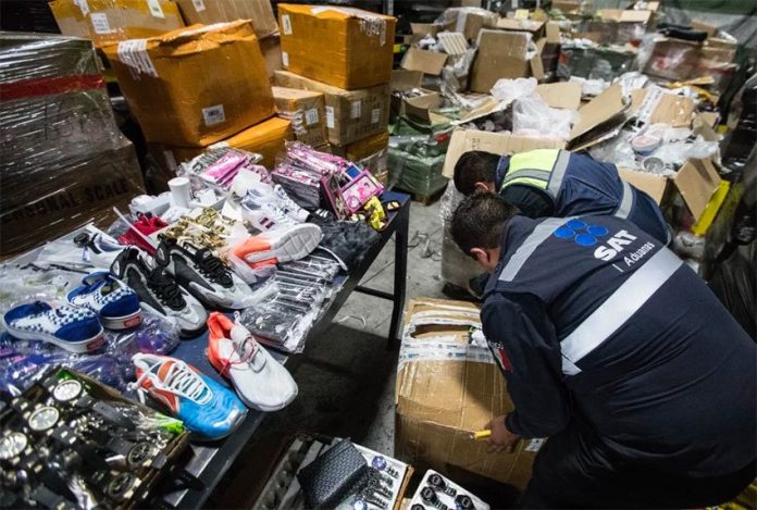 Customs agents inspect goods seized at Mexico City airport.
