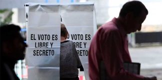 'The vote is free and secret,' the sign reminds voters at a polling station.