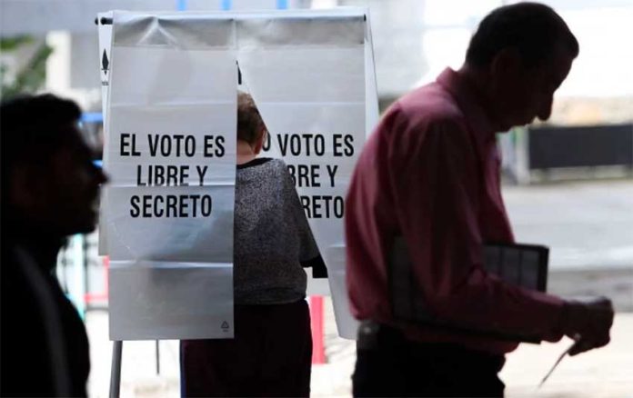 'The vote is free and secret,' the sign reminds voters at a polling station.