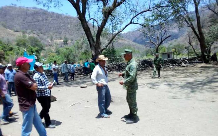 A farmer and a soldier parley in Guerrero.