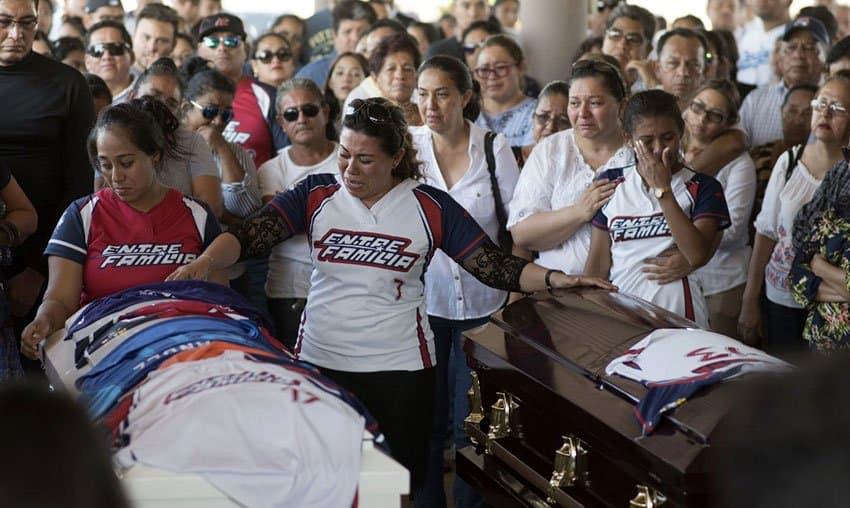 The funeral for two of the victims — a man and his infant son.