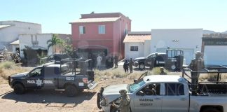 Security forces at the house where kidnapping victim was being held.