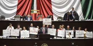 Labor Party legislators, who voted against the law, demonstrate their opposition to outsourcing.