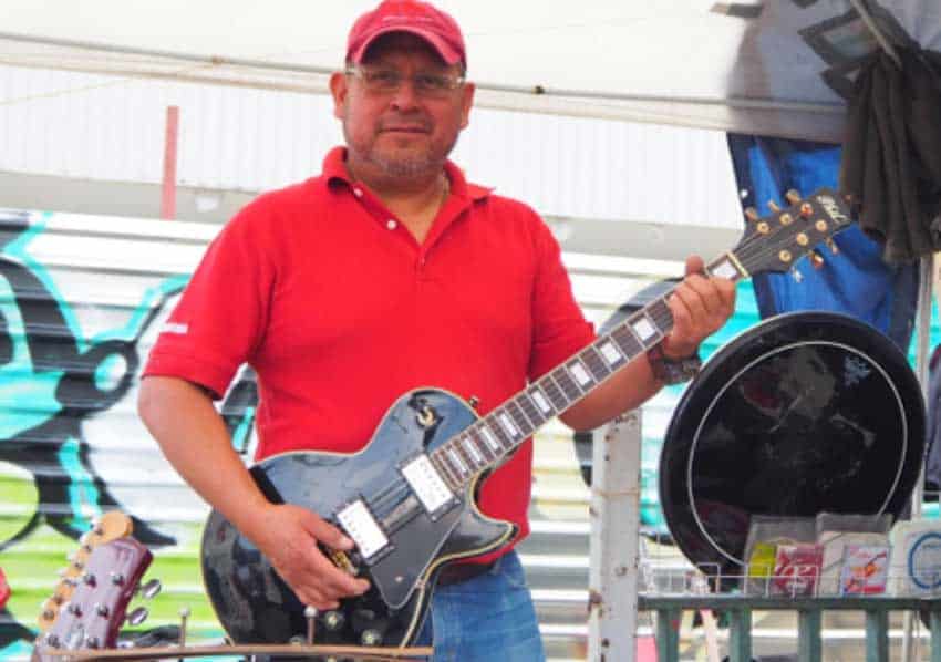 Guillermo Amaya poses with a guitar.