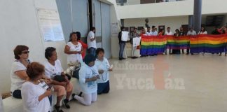 At left, opponents of the amendment pray while supporters wave the flag.