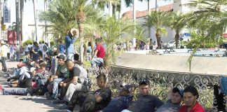 Migrants wait to see immigration agents in Mapastepec.