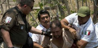 Immigration agents detain a migrant in Chiapas.