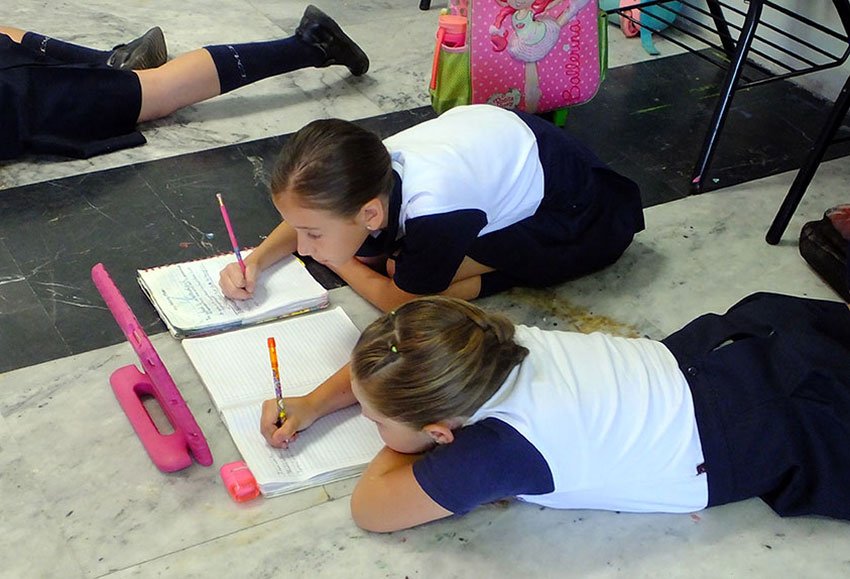 Students write questions in English. Lying on the floor is permitted.