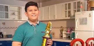 The young mathematician with one of his awards.