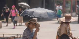 A woman shades herself from the sun in Mexico City, where more hot weather is in the forecast.
