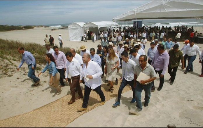 Governor Alfaro leads a tour of the beach during the announcement of a Costalegre development plan.