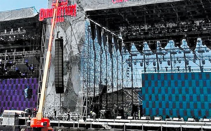 Workers erect the stage for the two-day festival Domination México.