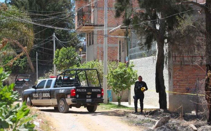 Police at the house in Tlajomulco where kidnapping victims were found.
