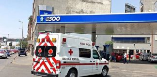 A Red Cross ambulance pulls into the gas station owned by the Red Cross president.