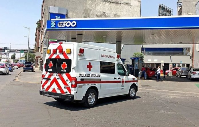A Red Cross ambulance pulls into the gas station owned by the Red Cross president.