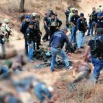 Security forces at the scene of crime gang shootout.